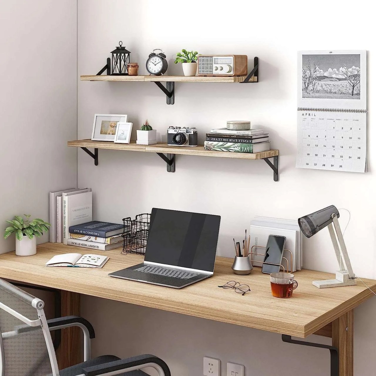 rustic wood shelves with black brackets above a home office desk