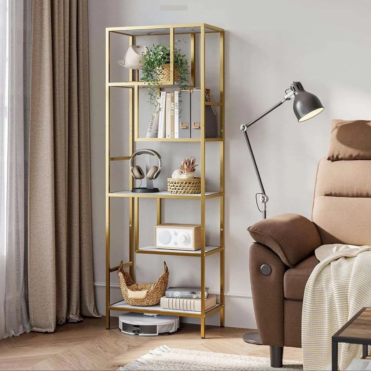 a gold and marble bookshelf in the living room