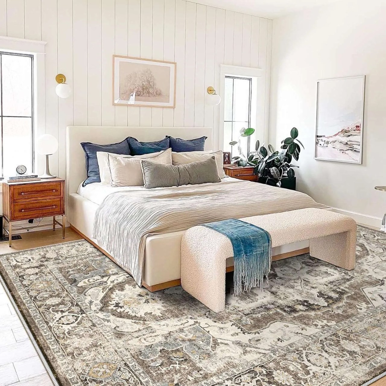 a neutral bedroom with white shiplap and a large grey area persian rug