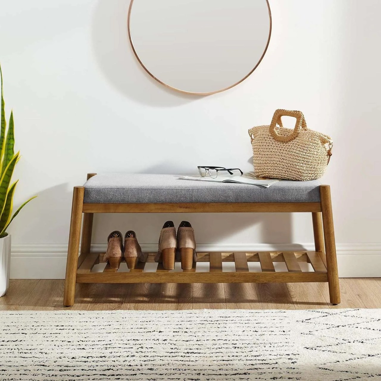 a walnut bench with storage underneath and a grey cushioned seat
