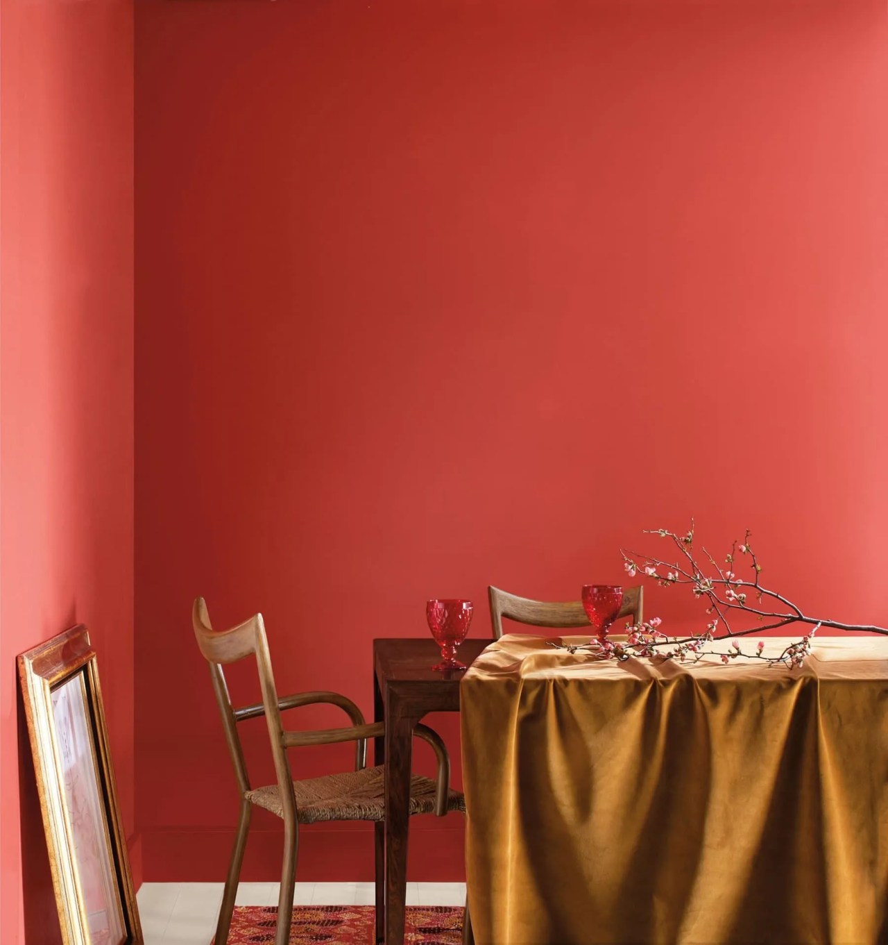 Benjamin Moore Raspberry Blush on the walls in the dining room with a gold tablecloth