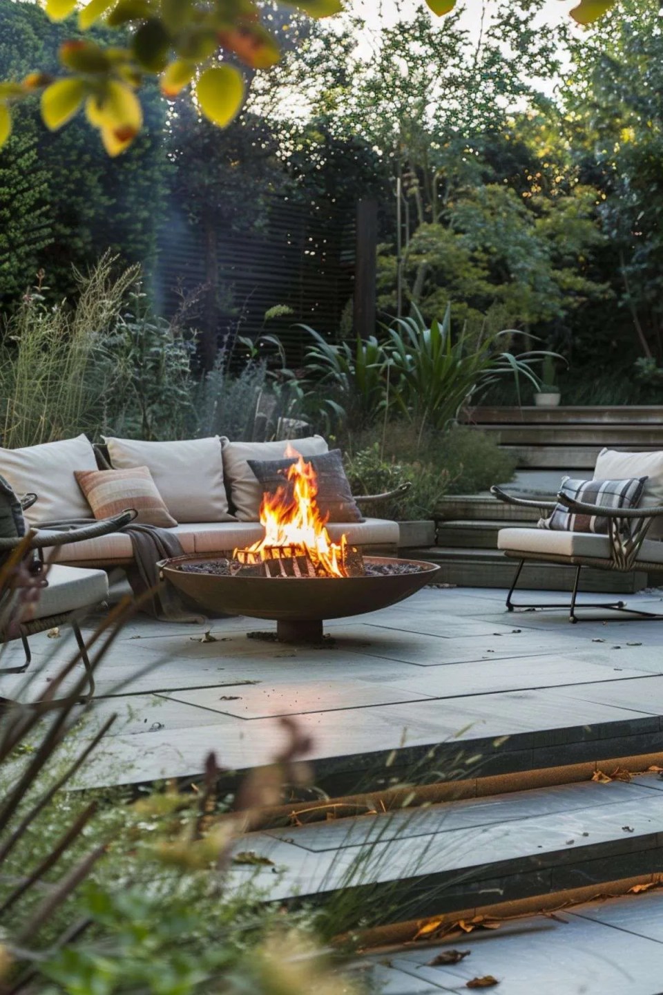 a garden seating area with cozy corner sofa and a firepit