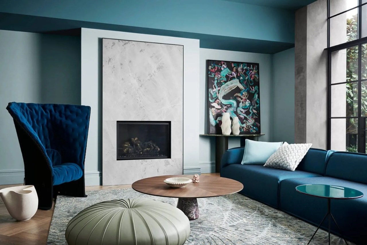 teal blues and greens painted around a marble fireplace