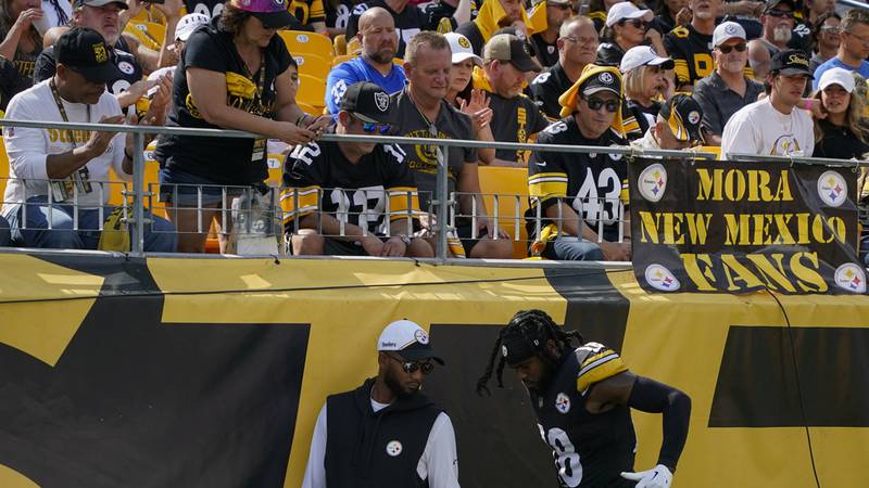 Pittsburgh Steelers wide receiver Diontae Johnson, right, walks off the field during the second...