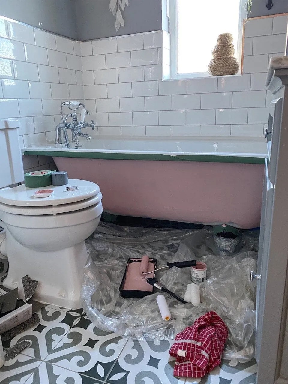 a bathroom being renovated and bath being painted