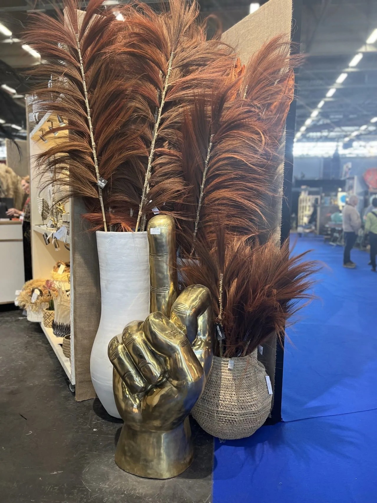 huge pampas grass in bronze and a bronze hand statue