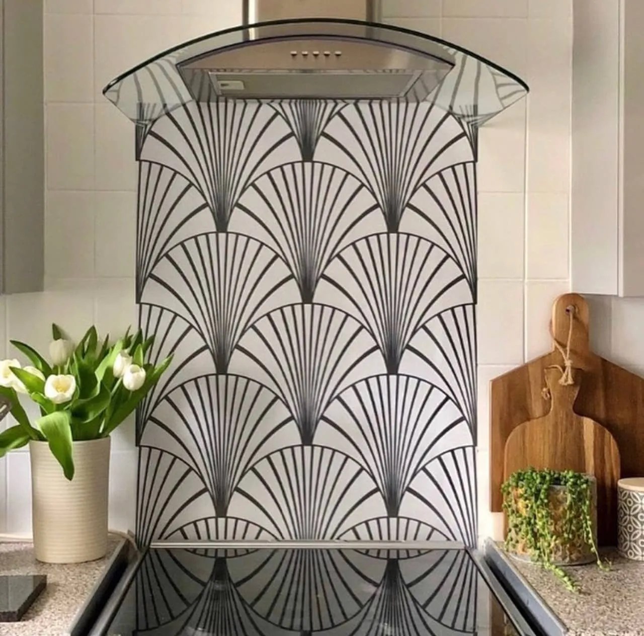 monochrome patterned backsplash above the over in the kitchen