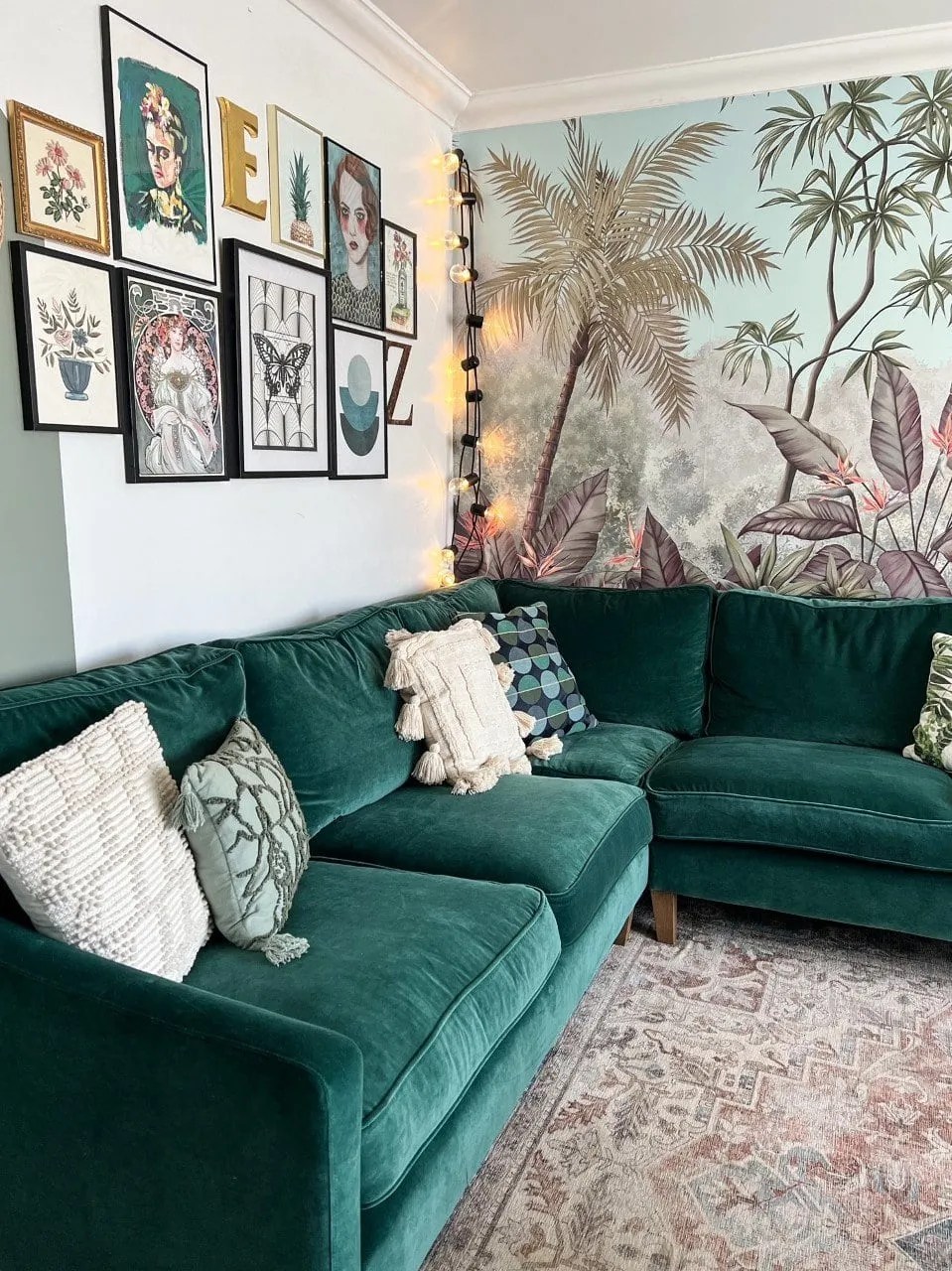 gallery wall, tangled jungle wallpaper and green velvet sofa in the living room