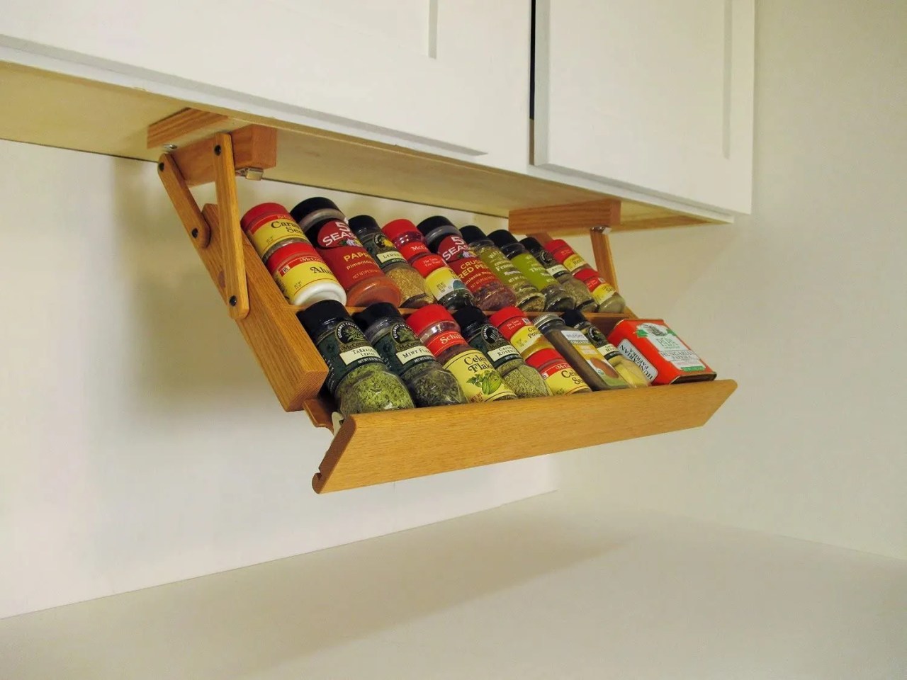 a drop-down tray for your spices that sits under a kitchen cabinet