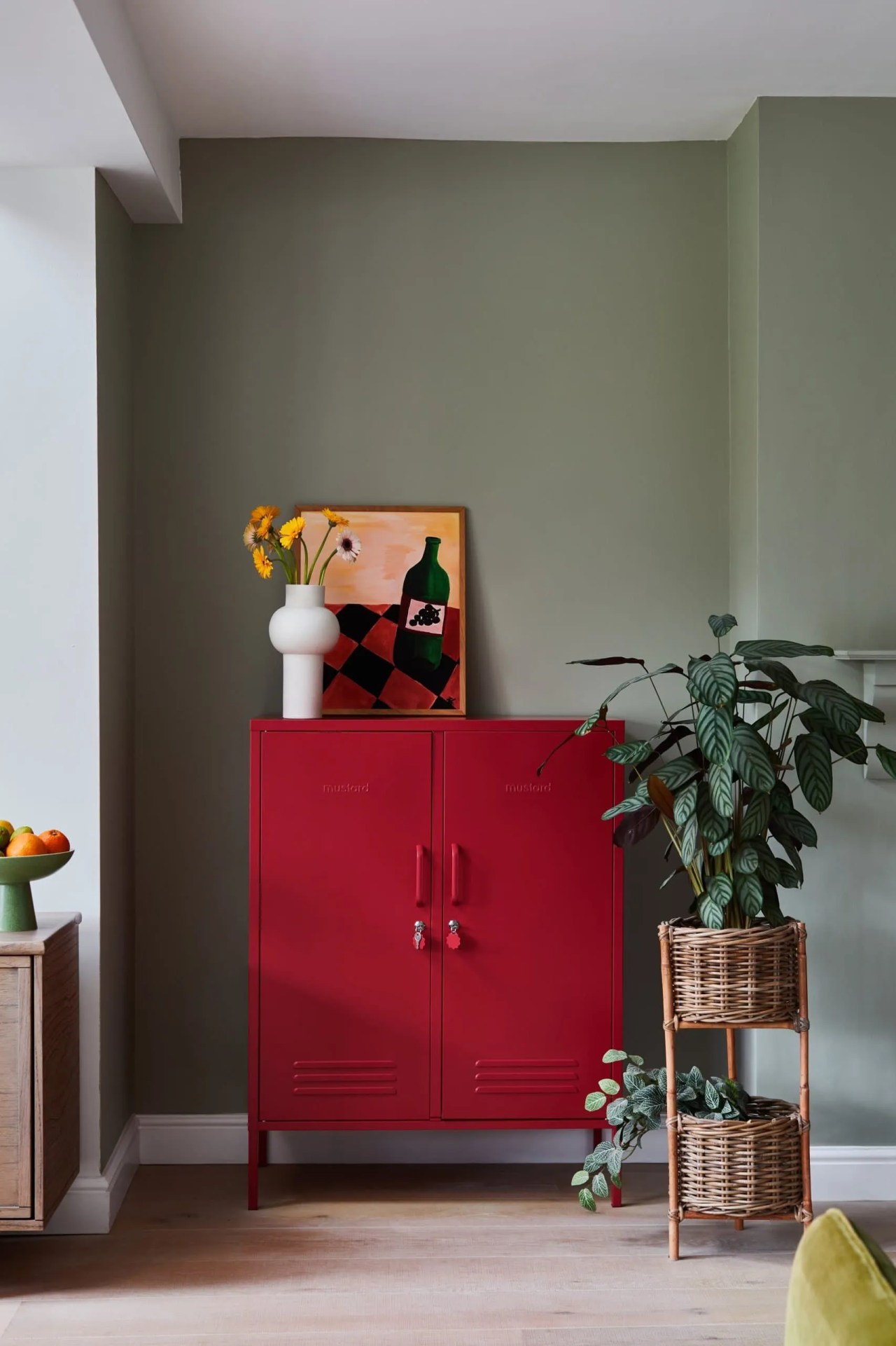 Poppy mustard made metal locker with a green wall backdrop