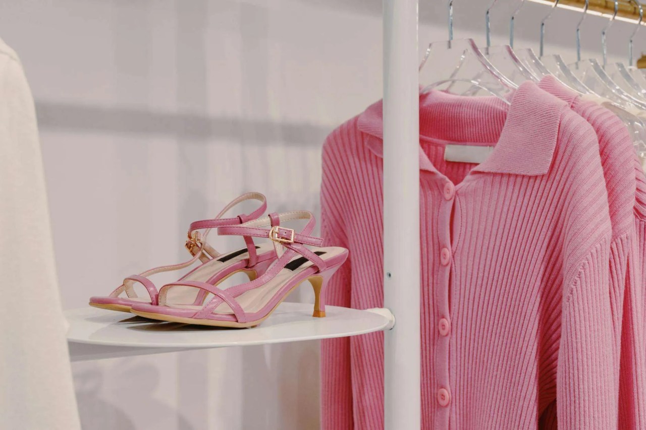 pink sandals beside a pink cardigan