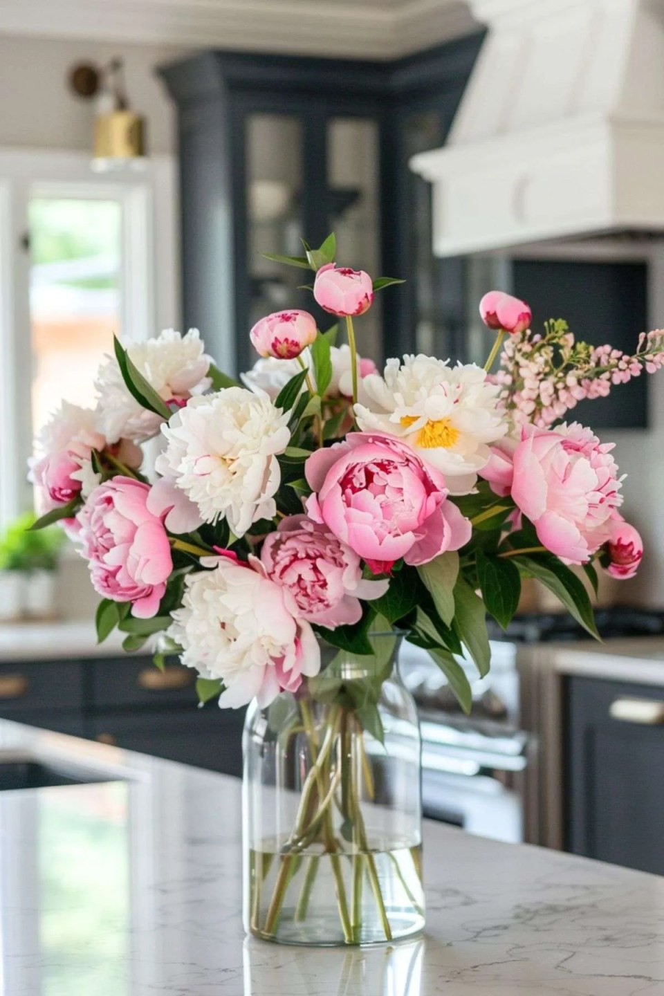 peonies in a vase in a kitchen