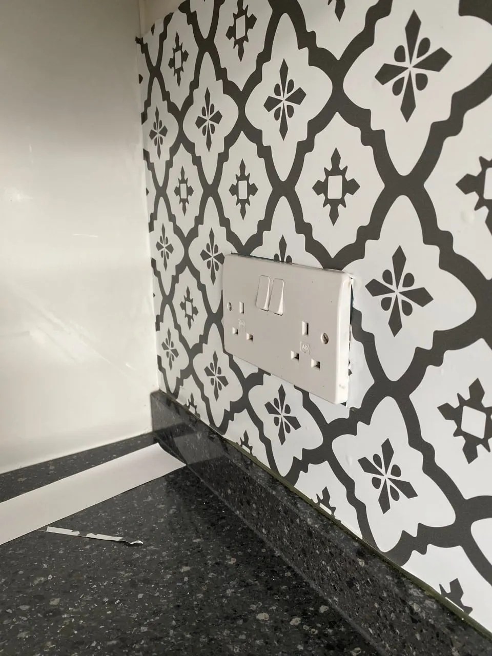 peel and stick tiles going around a plug socket