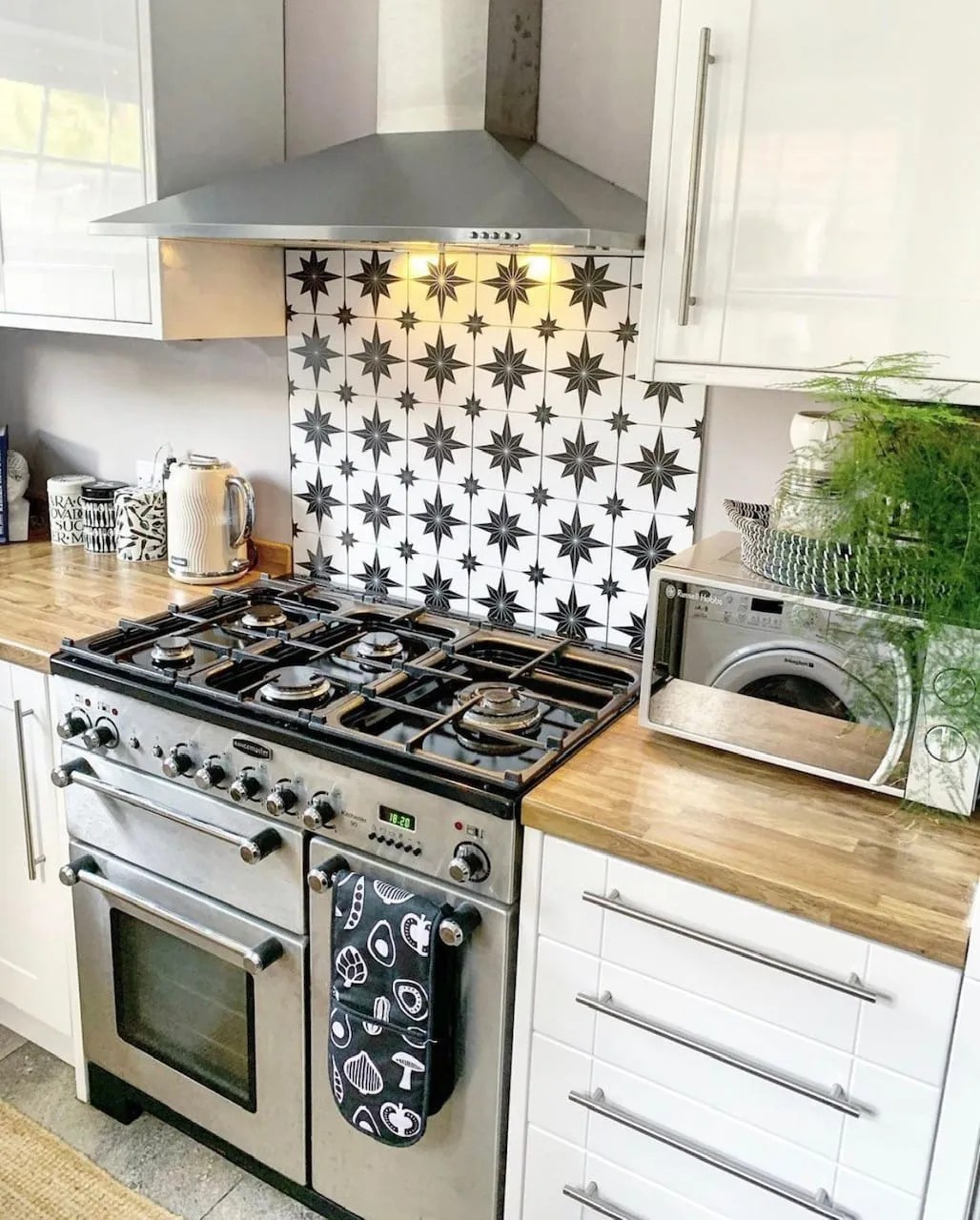 monochrome tiles in the kitchen above a range cooker 