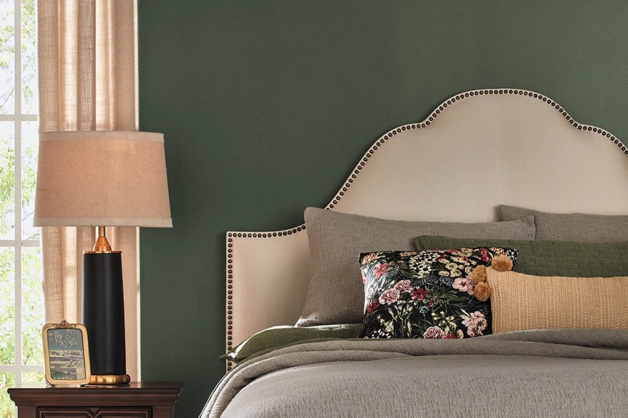 dark green walls in the living room with beige furnishings