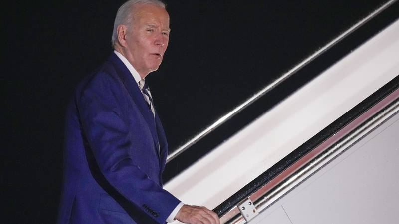 President Joe Biden answers a questions as he boards Air Force One at Andrews Air Force Base,...